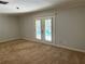 Bedroom with carpeted floors and French doors to the outside at 3336 Edgecliffe Dr, Orlando, FL 32806