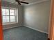 This carpeted bedroom features a ceiling fan and a window offering natural light at 3336 Edgecliffe Dr, Orlando, FL 32806