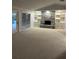 Spacious living room with a stone fireplace, built-in shelving, and sliding door access to outdoor area at 3336 Edgecliffe Dr, Orlando, FL 32806