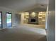 Spacious living room with stone fireplace, built-in shelving, and sliding glass doors to the pool at 3336 Edgecliffe Dr, Orlando, FL 32806