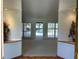 Open living room with neutral tones, sliding glass doors to the pool, and decorative flowers at 3336 Edgecliffe Dr, Orlando, FL 32806