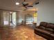Living room with tile floors, ceiling fan, wet bar, and sliding doors to the patio at 3336 Edgecliffe Dr, Orlando, FL 32806