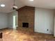 Living room with brick fireplace, ceiling fan, and tile floors at 3336 Edgecliffe Dr, Orlando, FL 32806