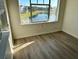 Bright living room with wood-look floors and large window offering a lake view at 4105 Tropical Isle Blvd # 238, Kissimmee, FL 34741