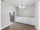 Dining area with white cabinets, granite counters and wood-look floors at 4803 S Texas Ave # B, Orlando, FL 32839