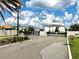 View of the community entrance and gate, featuring lush landscaping at 7944 Formosa Valley Pl, Kissimmee, FL 34747