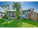 Landscaped backyard with lush grass and a wooden fence at 1713 Longleaf Dr, Saint Cloud, FL 34769