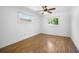 Simple bedroom with wood-look flooring and a ceiling fan at 1713 Longleaf Dr, Saint Cloud, FL 34769