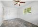 Bright bedroom with tile flooring, a ceiling fan, and a double door closet at 1713 Longleaf Dr, Saint Cloud, FL 34769