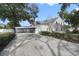 Two-story house with carport and paved driveway at 1020 Wisconsin Ave, Saint Cloud, FL 34769