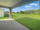 Covered lanai overlooking a lush green backyard, perfect for outdoor living at 4284 Sagefield Dr, Harmony, FL 34773