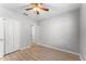 Empty bedroom featuring wood-look floors, a ceiling fan, closet and neutral paint, ready for personalization at 2134 Osprey Woods Cir, Orlando, FL 32820