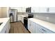 Modern kitchen featuring stainless steel appliances, quartz countertops, and stylish backsplash at 14771 Erice Ave, Clermont, FL 34714