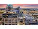 An aerial view of the city's buildings during a colorful evening sunset at 155 S Court Ave # 2710, Orlando, FL 32801