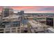 Breathtaking aerial view of city skyline featuring modern architecture, highways, and lush green areas under a sunset sky at 155 S Court Ave # 2710, Orlando, FL 32801