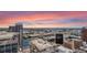 Picturesque cityscape with towering buildings, green spaces, and intricate highway systems as the sun sets at 155 S Court Ave # 2710, Orlando, FL 32801