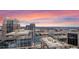 Spectacular aerial view capturing modern city buildings, roadways, and natural expanses under a colorful sunset at 155 S Court Ave # 2710, Orlando, FL 32801