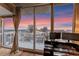 Breathtaking city view from balcony with desk and monitors, framed by floor-to-ceiling windows at 155 S Court Ave # 2710, Orlando, FL 32801