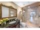 Elegant bathroom featuring granite countertop, ornate mirror, and glass-enclosed shower at 155 S Court Ave # 2710, Orlando, FL 32801
