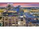 Dazzling skyline at dusk featuring modern buildings, vibrant city lights, and sunset sky at 155 S Court Ave # 2710, Orlando, FL 32801