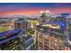 Beautiful city view featuring modern buildings against a vibrant sunset sky with city lights at 155 S Court Ave # 2710, Orlando, FL 32801