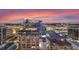 Expansive city view showcasing illuminated buildings against the sunset sky at 155 S Court Ave # 2710, Orlando, FL 32801