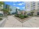 Beautiful courtyard with decorative shrubs and concrete planters beneath a bright sky and contemporary building at 155 S Court Ave # 2710, Orlando, FL 32801