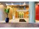 Inviting condo building entrance featuring colorful mosaic columns and modern glass doors at 155 S Court Ave # 2710, Orlando, FL 32801