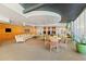Inviting lounge area with comfortable seating, a large television, and tables, providing a relaxing gathering space at 155 S Court Ave # 2710, Orlando, FL 32801
