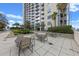 Luxury condominium features a patio with tables and chairs and decorative landscaping at 155 S Court Ave # 2710, Orlando, FL 32801
