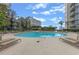 Exterior pool view featuring lounge chairs and nearby buildings with clear blue skies at 155 S Court Ave # 2710, Orlando, FL 32801