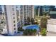 Luxury condominium featuring a beautiful outdoor pool surrounded by lush landscaping at 155 S Court Ave # 2710, Orlando, FL 32801