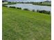 Expansive backyard with lush lawn and serene waterfront views at 420 Quarry Rock Cir, Kissimmee, FL 34758