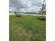 Scenic backyard overlooking a tranquil lake with beautiful landscaping at 420 Quarry Rock Cir, Kissimmee, FL 34758