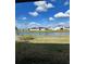 Scenic backyard view overlooking a serene pond under a beautiful sky with scattered clouds at 420 Quarry Rock Cir, Kissimmee, FL 34758