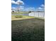 Spacious backyard featuring a fence and a view of a tranquil pond and neighborhood homes at 420 Quarry Rock Cir, Kissimmee, FL 34758