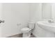 Powder room featuring a white toilet and pedestal sink over tile floor at 4308 Ranch House Rd, Saint Cloud, FL 34772