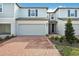 Charming light blue townhome with a brick paver driveway and a spacious two-car garage at 4308 Ranch House Rd, Saint Cloud, FL 34772