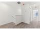 Second floor hallway with neutral carpet, white walls and trim, and natural light at 4308 Ranch House Rd, Saint Cloud, FL 34772