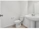 Well-lit half bathroom with a pedestal sink, ceramic tile flooring, and white walls at 4316 Ranch House Rd, Saint Cloud, FL 34772