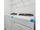 Bright laundry room with a modern washer and dryer set and wire shelving above at 4316 Ranch House Rd, Saint Cloud, FL 34772