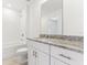 Modern bathroom with granite countertops, white cabinets, shower, and bathtub at 4320 Ranch House Rd, Saint Cloud, FL 34772