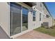 View of sliding glass doors to back patio with red brick pavers and view of AC unit at 4368 Ranch House Rd, Saint Cloud, FL 34772