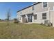 A spacious backyard with a patio, gray siding, a grassy yard, and an exterior entrance at 4368 Ranch House Rd, Saint Cloud, FL 34772