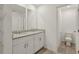 Bathroom featuring dual sink vanity with granite counters and a separate toilet room at 4368 Ranch House Rd, Saint Cloud, FL 34772