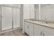 Bathroom featuring dual sink vanity, granite countertops, and a glass enclosed shower at 4368 Ranch House Rd, Saint Cloud, FL 34772