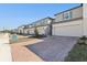 Modern townhomes featuring attached garages, and brick-paved driveways with landscaped front yards at 4368 Ranch House Rd, Saint Cloud, FL 34772