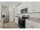 Modern kitchen featuring stainless steel appliances, white cabinets, and granite countertops at 4368 Ranch House Rd, Saint Cloud, FL 34772