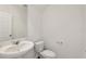 Powder room featuring a pedestal sink, toilet, and mirror at 4368 Ranch House Rd, Saint Cloud, FL 34772