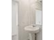 Powder room with pedestal sink, brushed nickel faucet, and an open doorway with tile flooring at 4368 Ranch House Rd, Saint Cloud, FL 34772